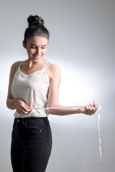 young-woman-measuring-waist-with-tape-against-gray-background_1048944-16004913 young-woman-measuring-waist-with-tape-against-gray-background_1048944-16004913